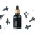 Black glass bottle with wooden cap containing BIO Silver Fir essential oil surrounded by fresh needles on white background