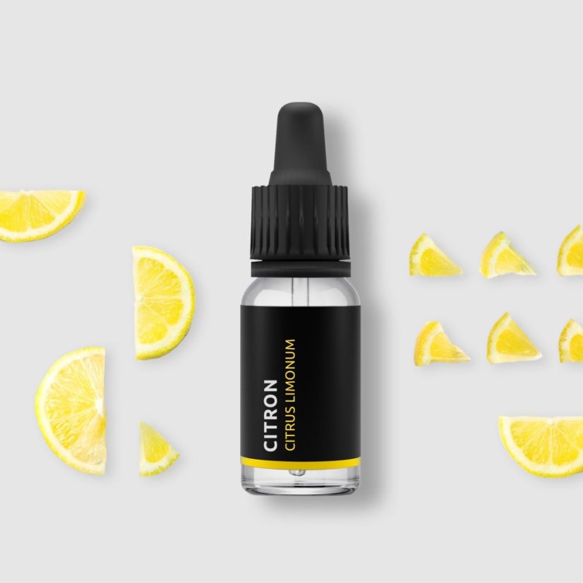 BIO lemon essential oil in black glass bottle with dropper surrounded by fresh yellow lemon slices on white background
